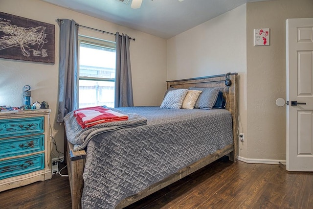 bedroom with ceiling fan and dark hardwood / wood-style flooring