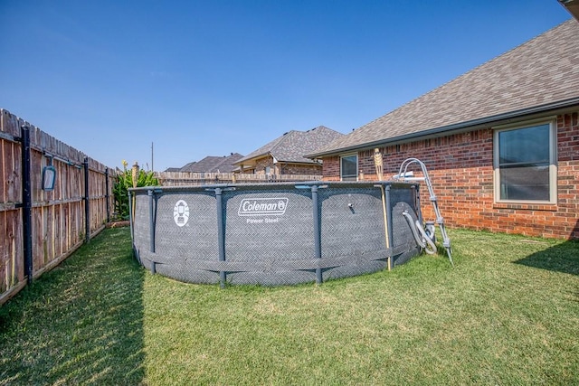 view of pool featuring a yard