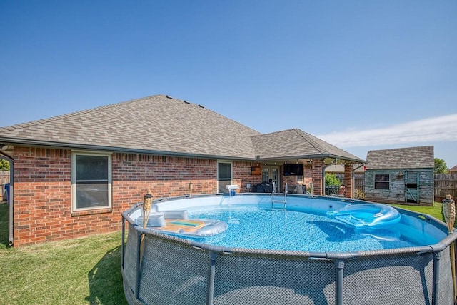 view of pool featuring an outbuilding and a yard