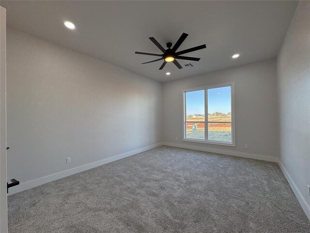 spare room with carpet floors and ceiling fan