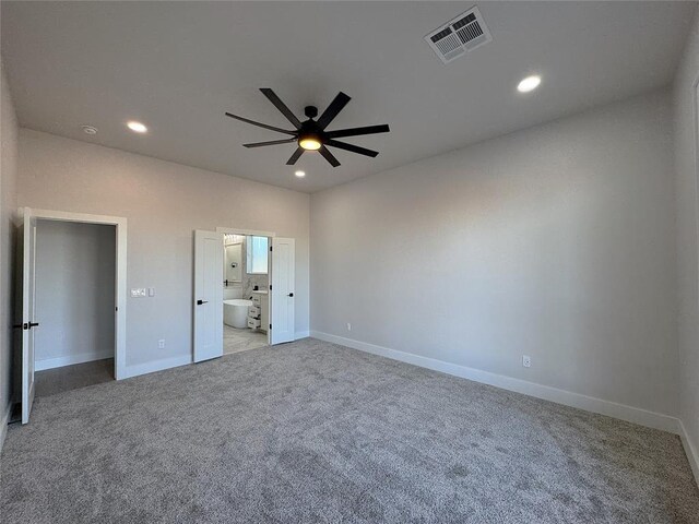 unfurnished bedroom with connected bathroom, ceiling fan, and light carpet