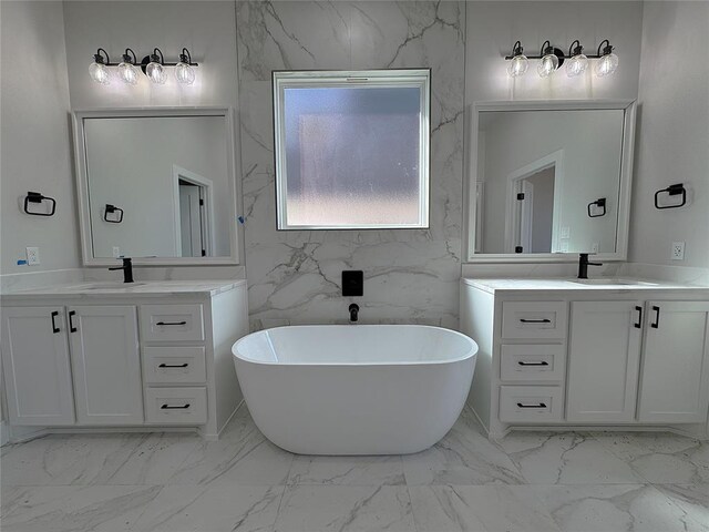 bathroom with a bathing tub, vanity, and tile walls