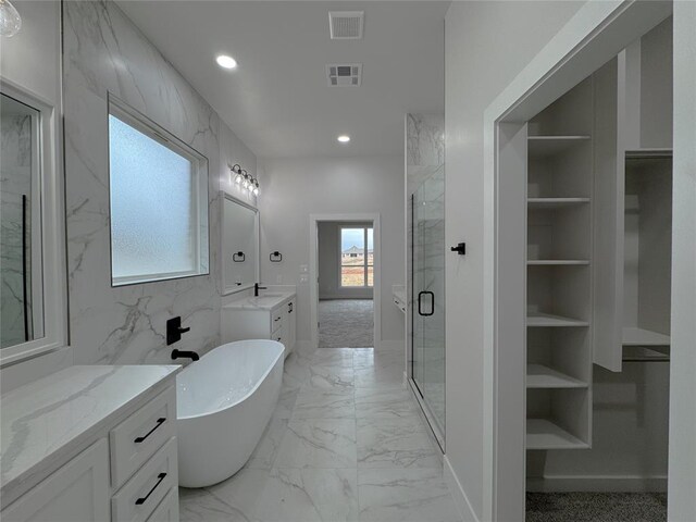 bathroom with vanity, separate shower and tub, and built in features