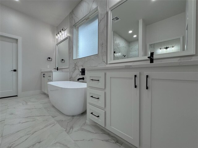 bathroom with vanity and a tub to relax in