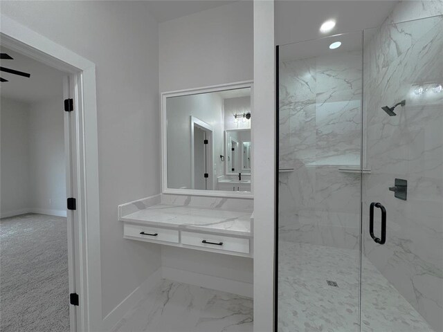 bathroom with vanity and a shower with door