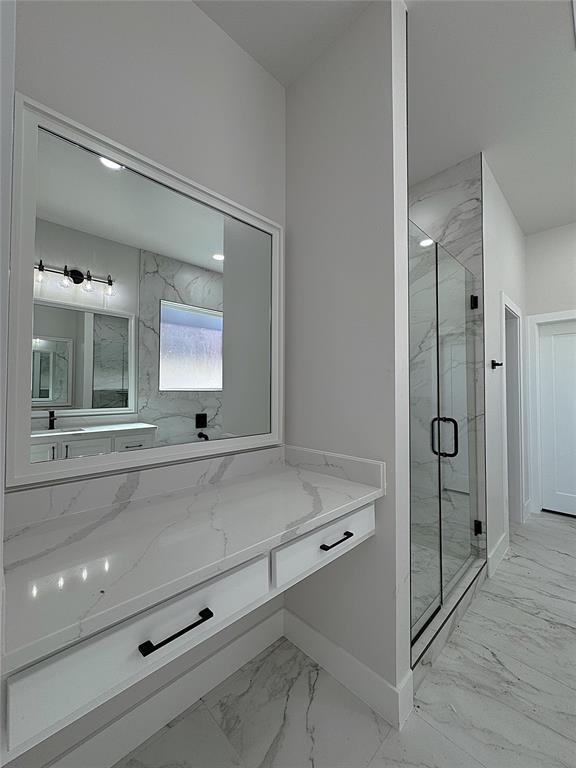 bathroom featuring vanity and an enclosed shower