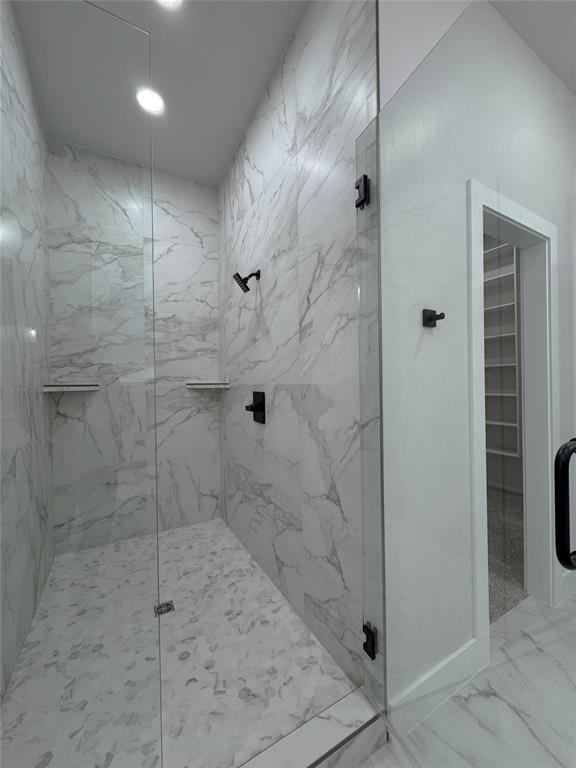 bathroom featuring a shower with shower door