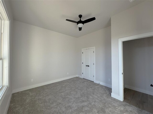 unfurnished bedroom with ceiling fan and carpet floors