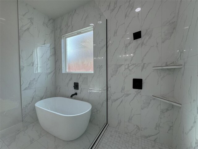 bathroom with a washtub and tile walls