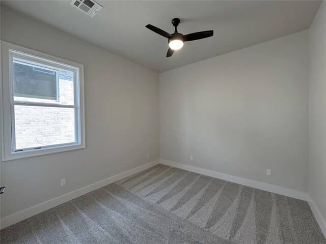 carpeted spare room featuring ceiling fan