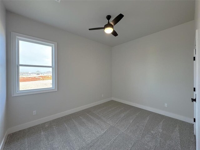 spare room featuring ceiling fan and carpet floors