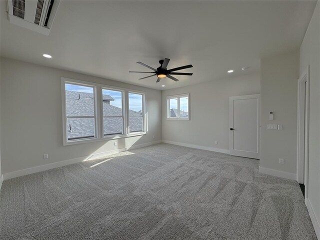 carpeted spare room with ceiling fan