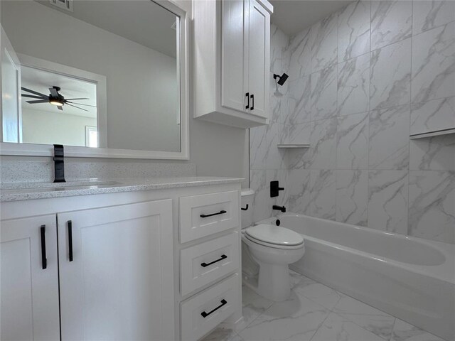 full bathroom featuring toilet, vanity, tiled shower / bath combo, and ceiling fan