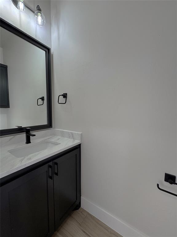 bathroom featuring hardwood / wood-style floors and vanity