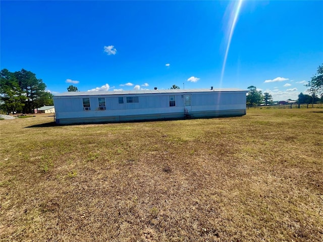 rear view of property with a yard