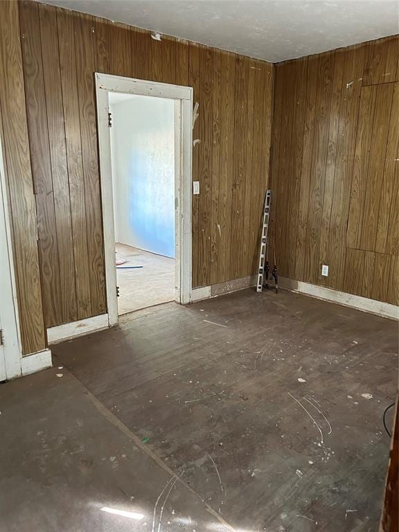 unfurnished room with wooden walls