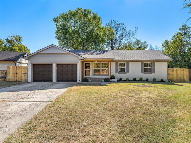 ranch-style house featuring a front lawn and a garage