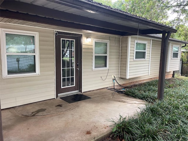 property entrance featuring a patio