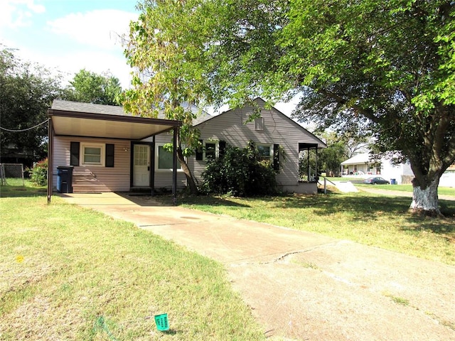 view of front facade with a carport and a front yard