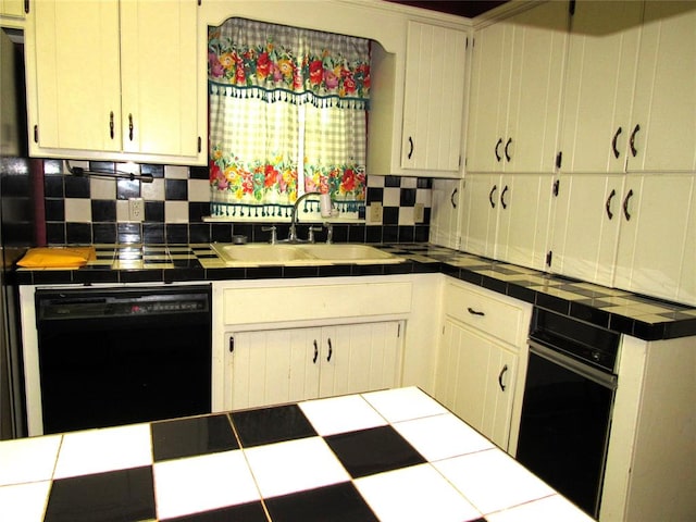 kitchen with tile countertops, decorative backsplash, sink, and black appliances