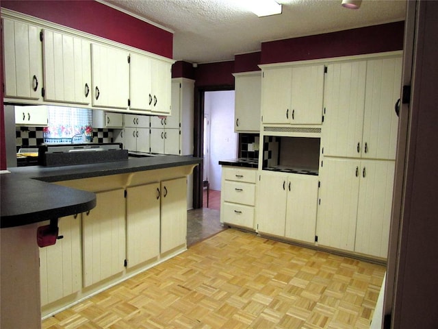 kitchen featuring a textured ceiling and light parquet floors