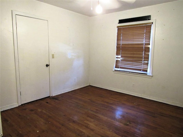 spare room with dark wood-type flooring