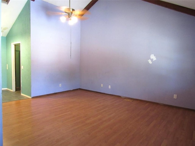 spare room with ceiling fan, high vaulted ceiling, and wood-type flooring