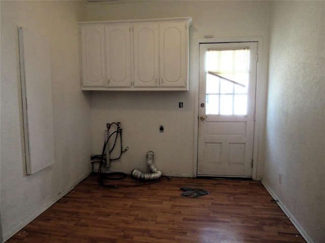 washroom featuring hookup for an electric dryer, cabinets, dark wood-type flooring, and washer hookup