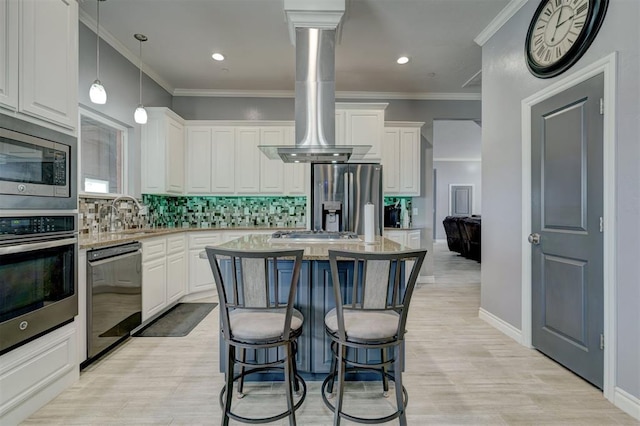 kitchen featuring a kitchen island, appliances with stainless steel finishes, island range hood, decorative light fixtures, and white cabinetry