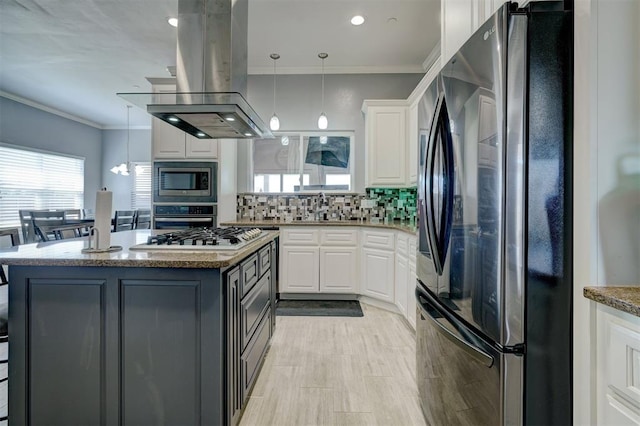 kitchen featuring white cabinetry, decorative light fixtures, a kitchen island, island exhaust hood, and stainless steel appliances