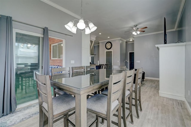 dining area featuring ornamental molding, ceiling fan with notable chandelier, and light hardwood / wood-style flooring