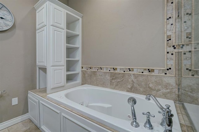 bathroom featuring tiled bath and tile patterned flooring