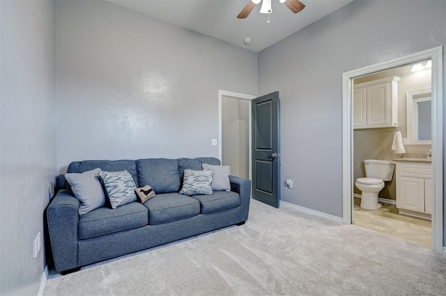 carpeted living room featuring ceiling fan