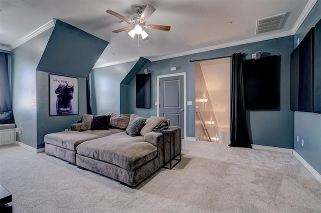 cinema room with crown molding, ceiling fan, and carpet flooring