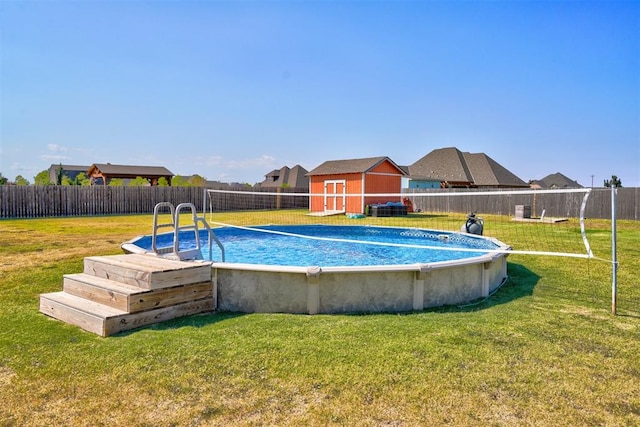 view of swimming pool featuring a shed and a lawn