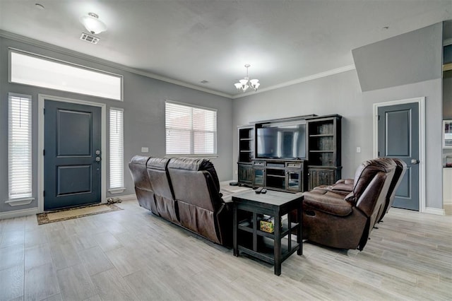 living room featuring crown molding, a chandelier, and light hardwood / wood-style flooring