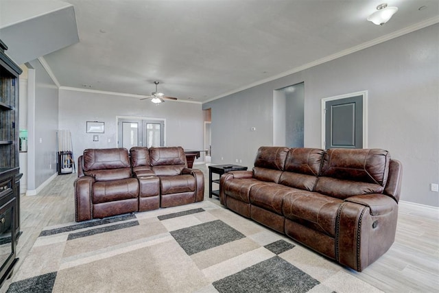 living room with crown molding, light hardwood / wood-style flooring, and ceiling fan