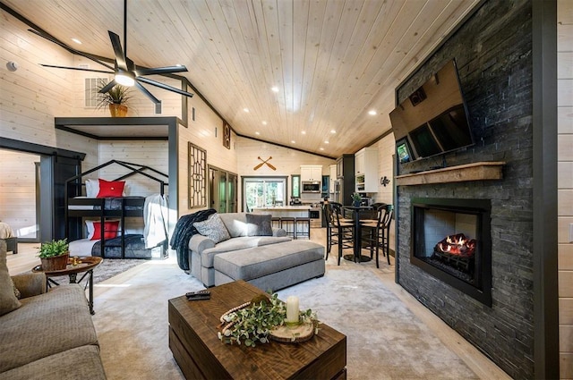 living room with ceiling fan, a stone fireplace, wooden ceiling, and high vaulted ceiling