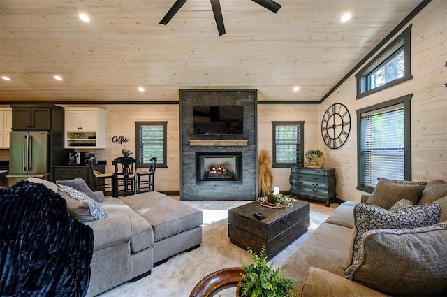 living room with ceiling fan, a large fireplace, lofted ceiling, and wood ceiling