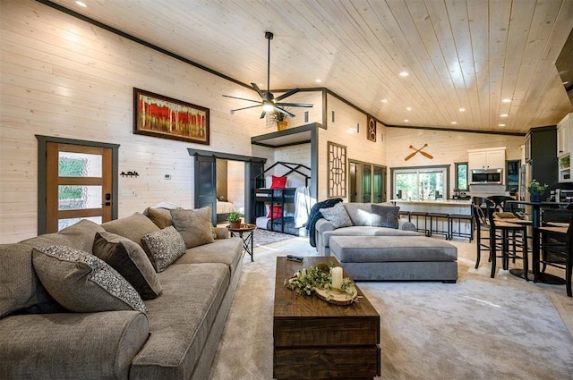 carpeted living room featuring ceiling fan, wooden walls, high vaulted ceiling, and wooden ceiling