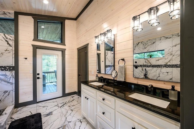 bathroom with vanity, wooden ceiling, and wooden walls