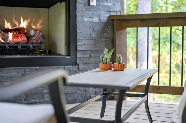 wooden balcony featuring a fireplace and a wooden deck