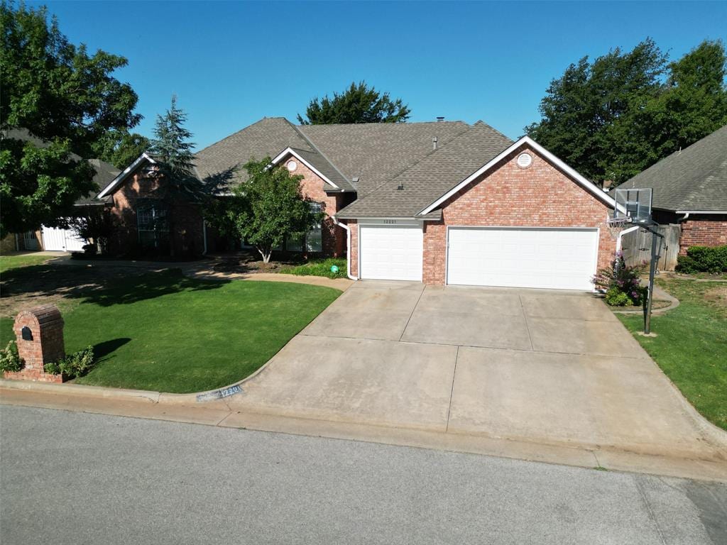 view of front of home featuring a garage and a front lawn