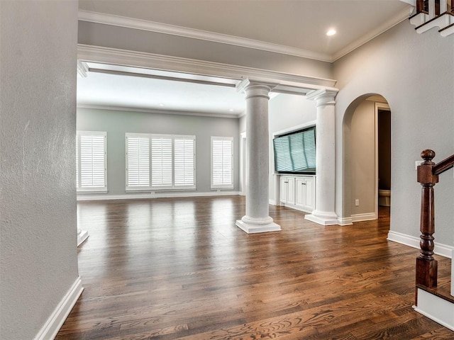 unfurnished living room featuring crown molding, dark wood-type flooring, and a wealth of natural light