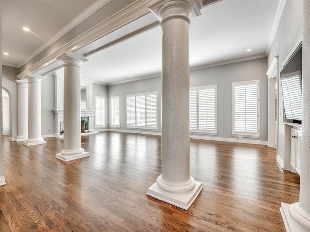 unfurnished living room with crown molding and wood-type flooring