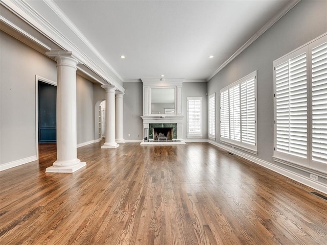 unfurnished living room featuring wood-type flooring, crown molding, and a high end fireplace