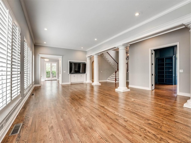 unfurnished living room with french doors, light hardwood / wood-style flooring, and ornamental molding