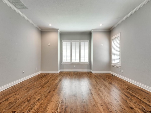 spare room featuring hardwood / wood-style flooring and ornamental molding