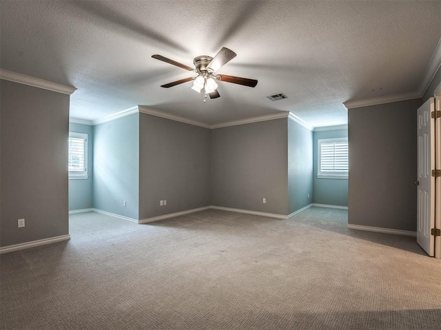 additional living space featuring a textured ceiling, light colored carpet, ceiling fan, and a healthy amount of sunlight