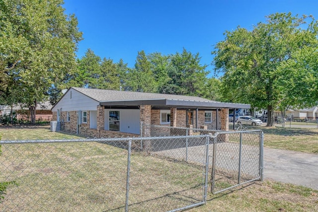 ranch-style home featuring cooling unit and a front yard